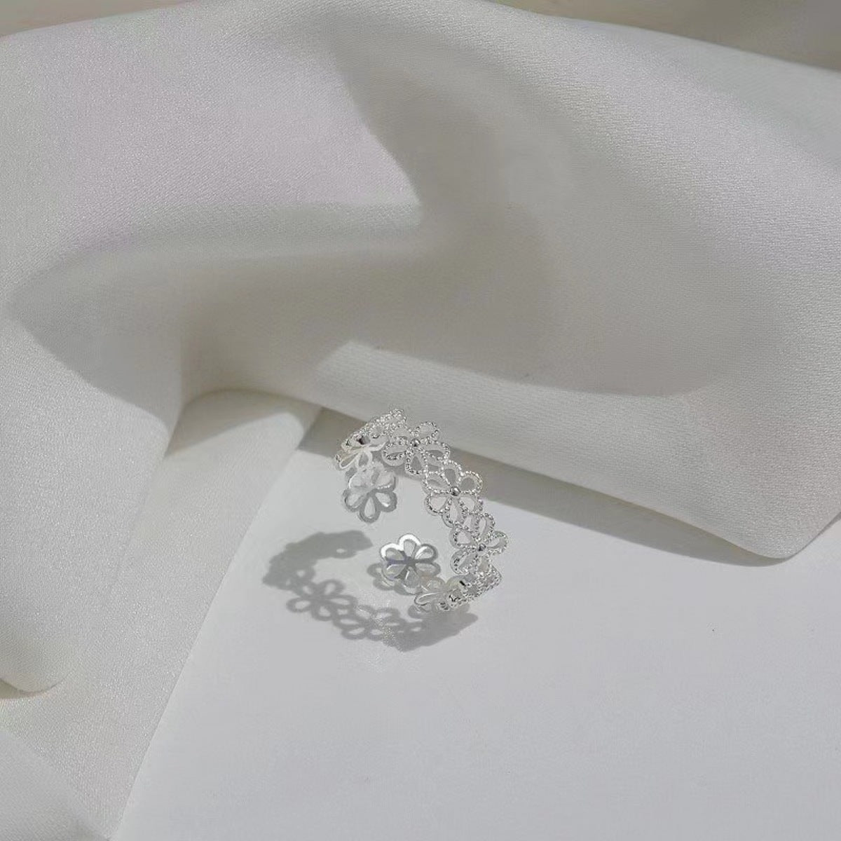 Detail of delicate floral engraving against sterling silver metal