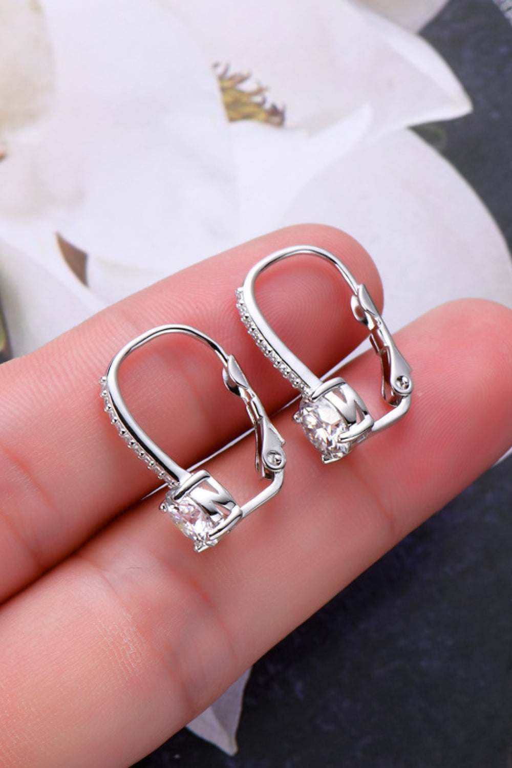 Side profile of minimalist moissanite stud earrings highlighting setting