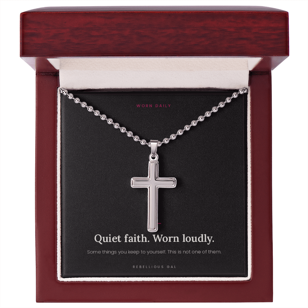 Steel cross pendant and ball chain centered in an open mahogany wood gift box