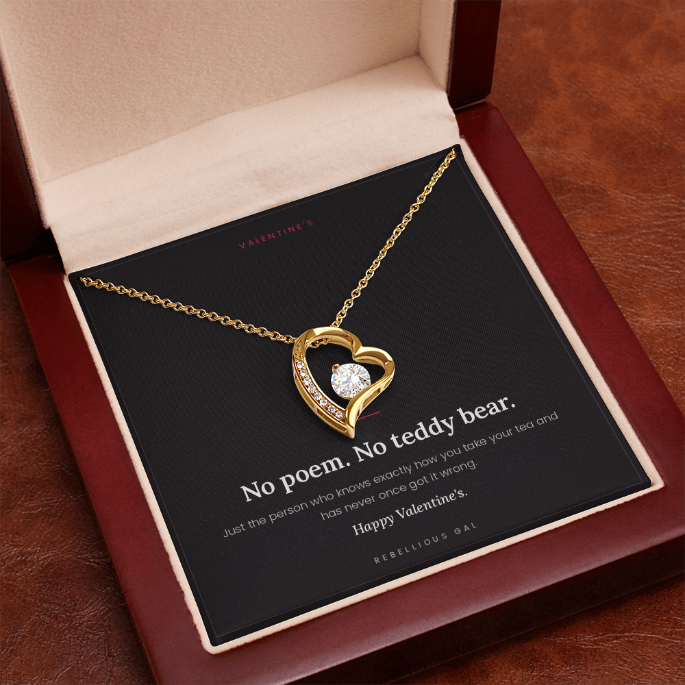 Yellow gold heart pendant with clear stone, No Poem card in a cream-lined mahogany box
