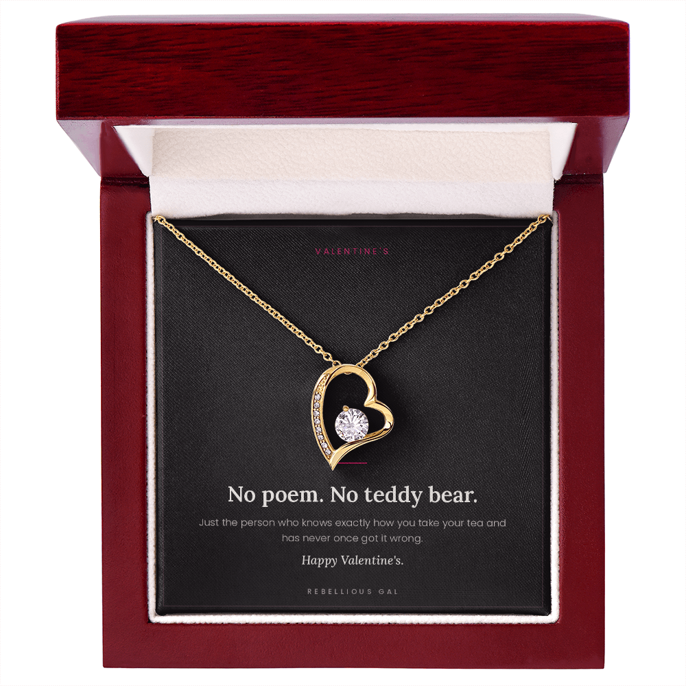 Yellow gold heart pendant on the No Poem Valentine's card in an open mahogany box