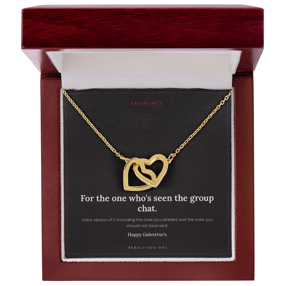 Gold interlocking heart pendant necklace on a black card inside an upright mahogany gift box