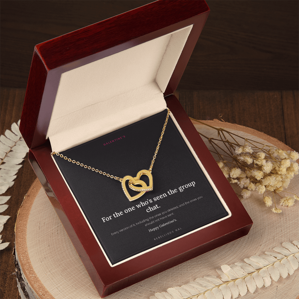 Mahogany gift box holding the gold heart necklace, angled on a wood slab with dried flowers