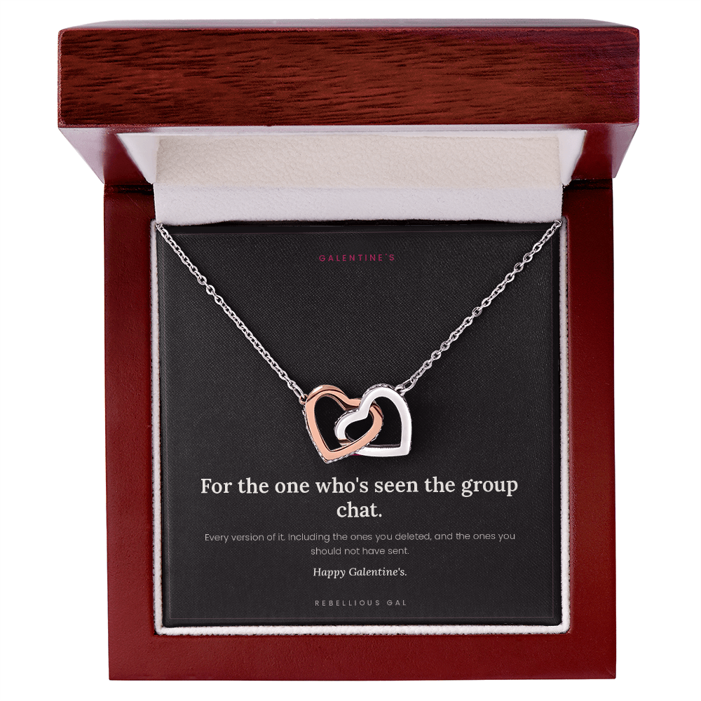 Open mahogany gift box with cream lining holding the silver and rose gold heart necklace