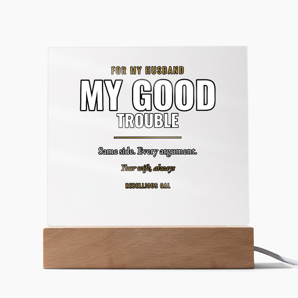 Dark lettering on the clear panel, light oak base, plain white studio background