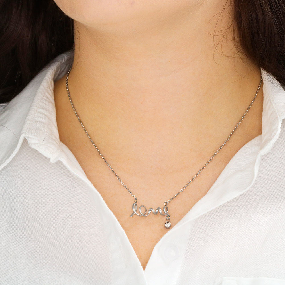 women in white, silver love necklace