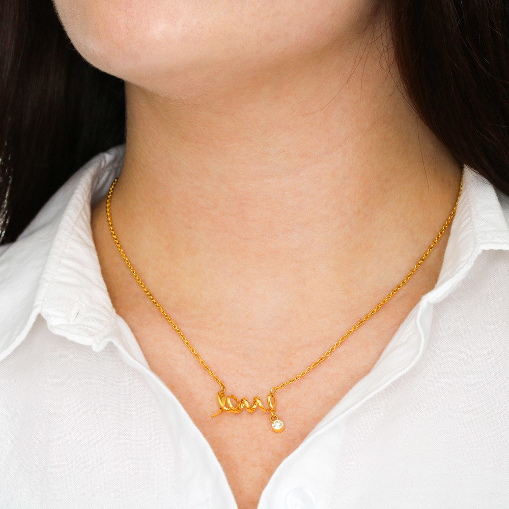 women in white wearing a love necklace