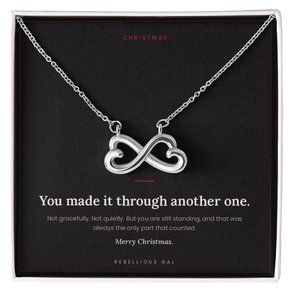 Silver infinity heart pendant necklace on a black message card in a white gift box