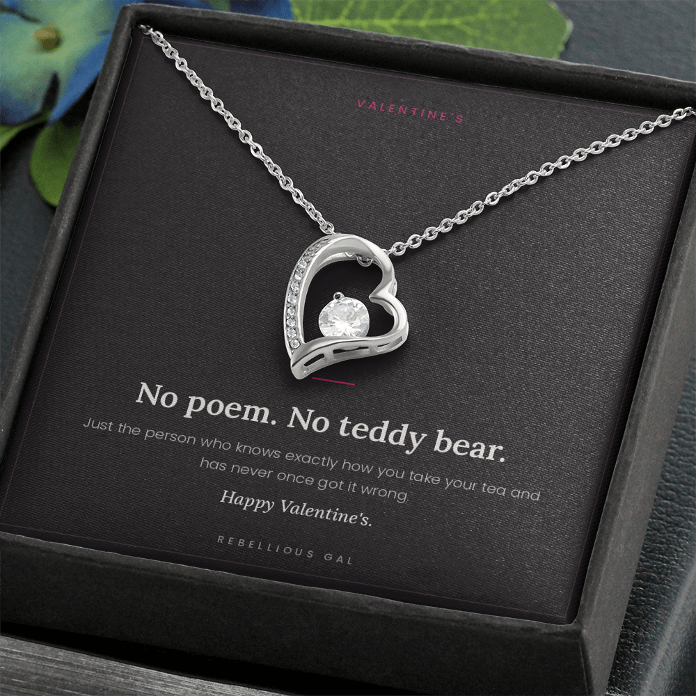 aSilver heart pendant necklace in an open black gift box with the No Poem card