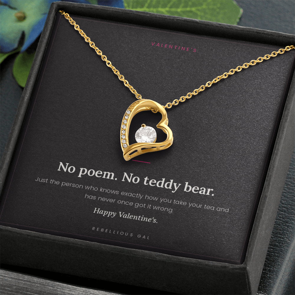 aGold heart pendant necklace in an open black gift box with the No Poem card