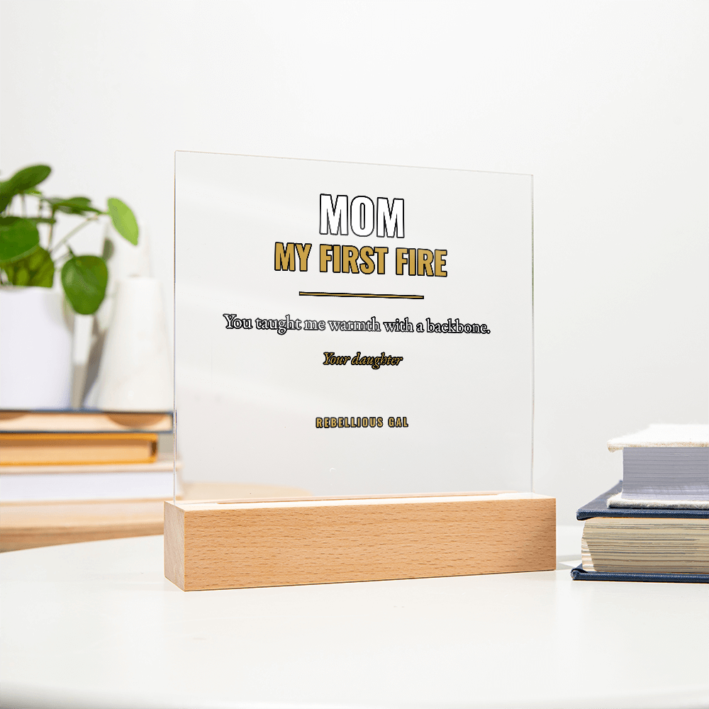 Trailing houseplant and two book stacks flank the transparent square on a white desk