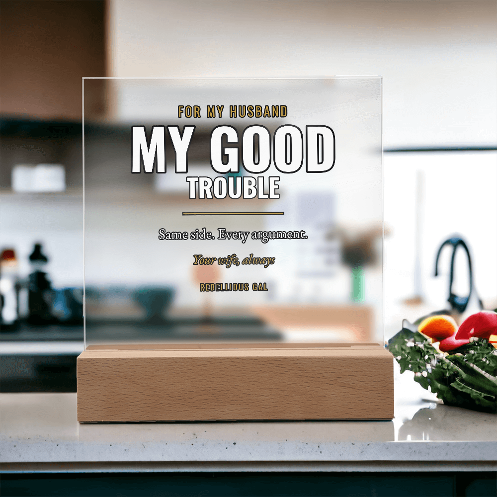 Pale kitchen counter, clear panel beside a bowl of dark greens and red peppers