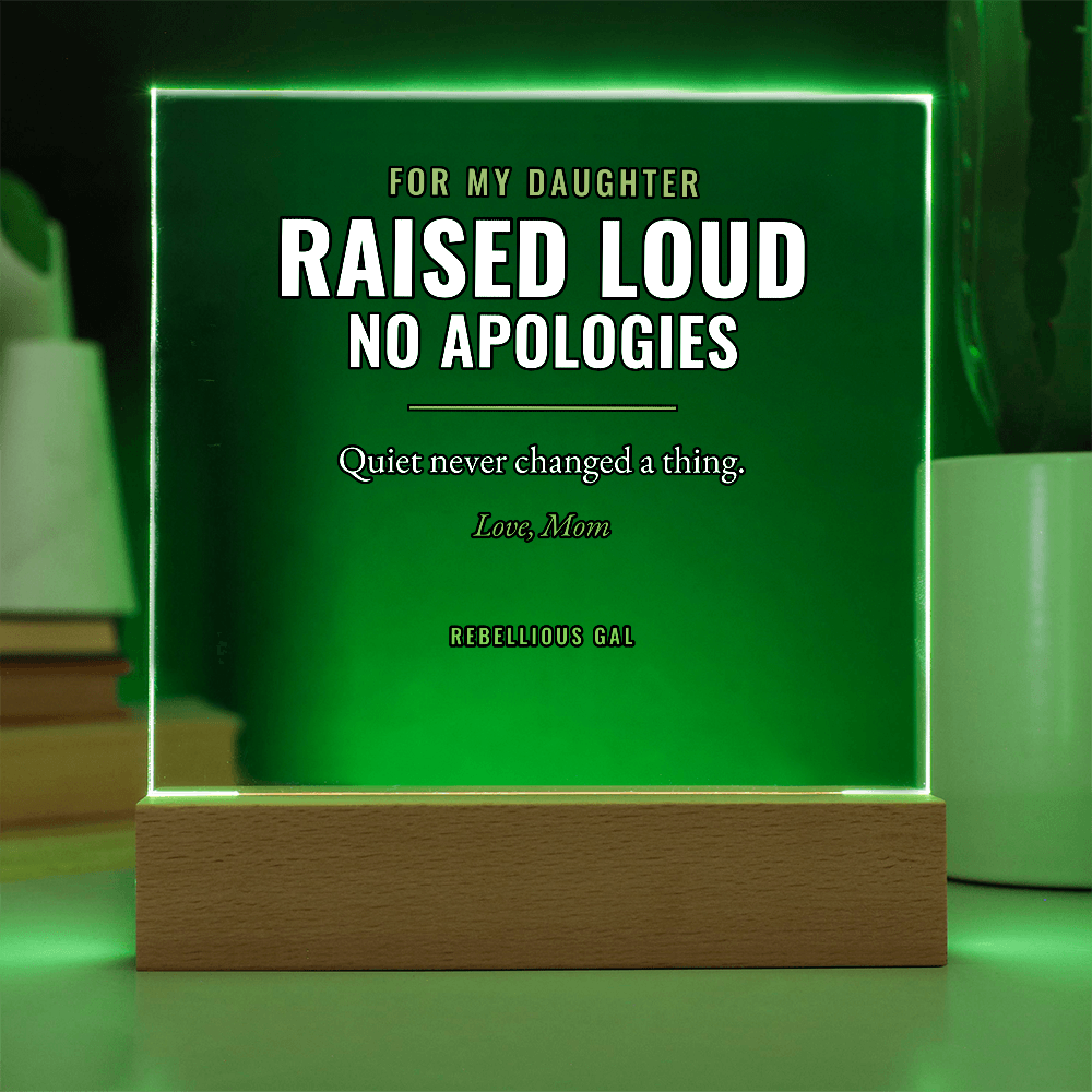 Green edge lighting washes the panel and its honey wood base, planter and leaves behind