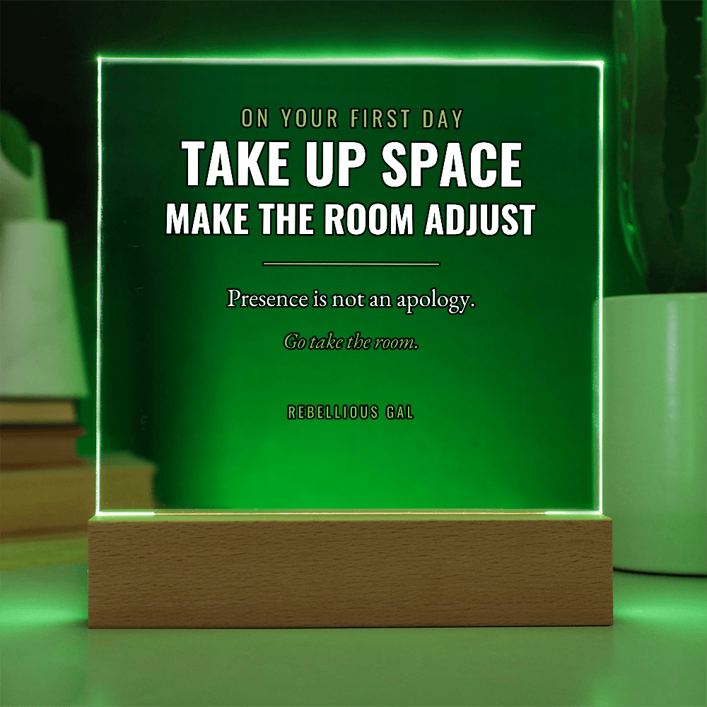 Green light pouring through the acrylic, blurred book spines left, a ribbed cactus right