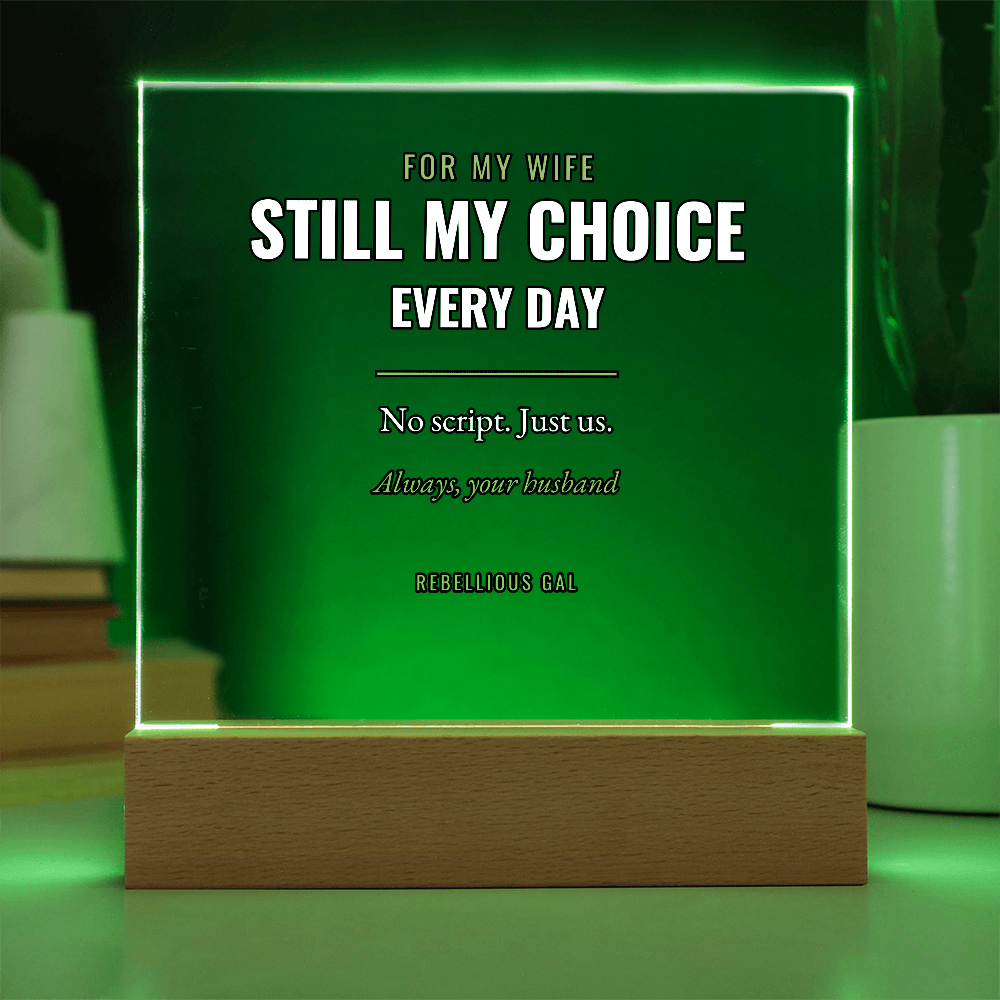Emerald glow spills off the panel into a dark room, ribbed cactus standing at right