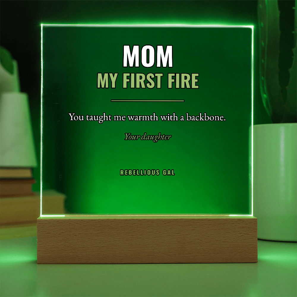 Vivid green light saturates the square, tinting blurred books stacked behind the wood base