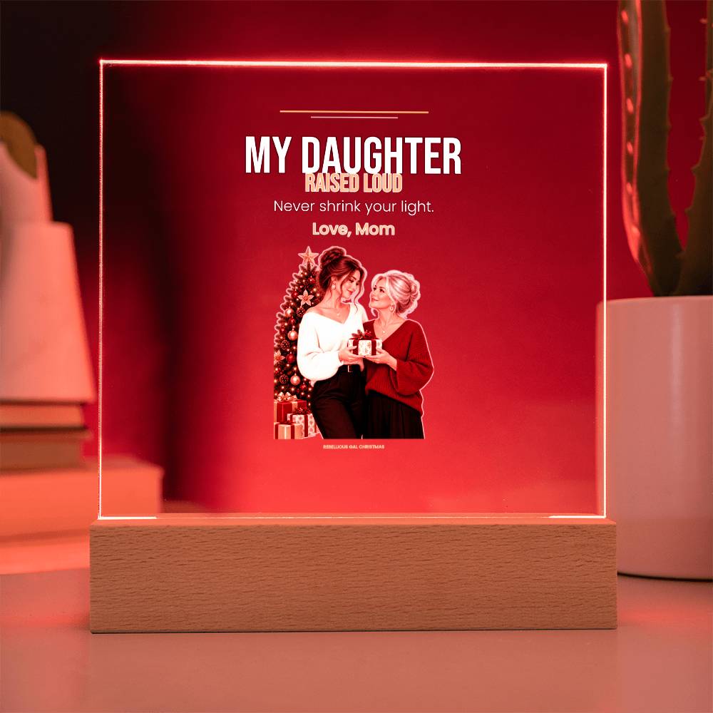 Red glow floods the panel behind the printed mother and daughter, pale stand below