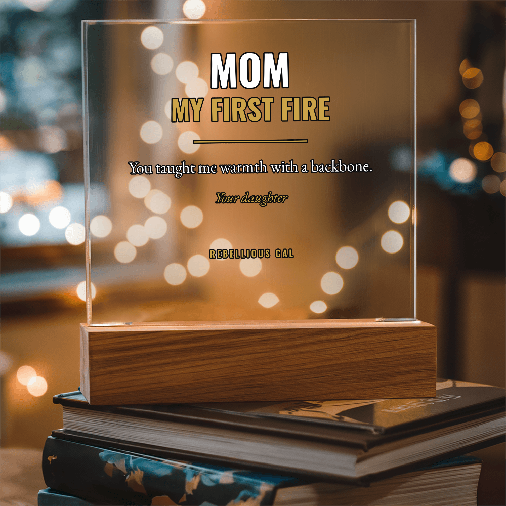 Golden bokeh shows through the clear acrylic, its wood base angled on hardback books