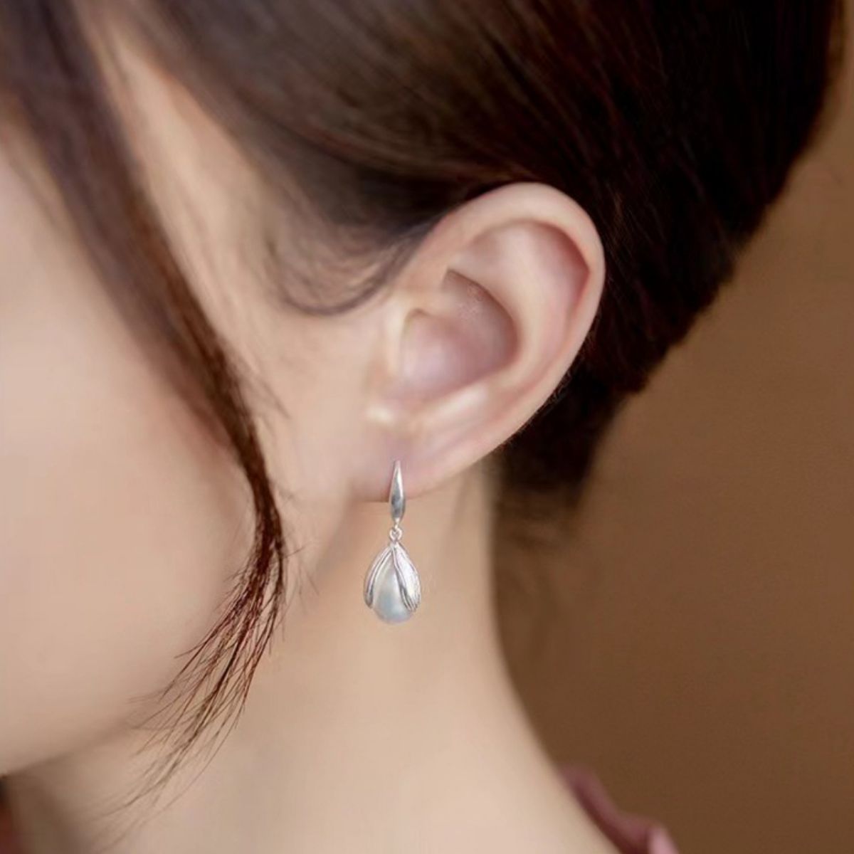 Model showing movement of the 1.2" pearl drop earrings in action