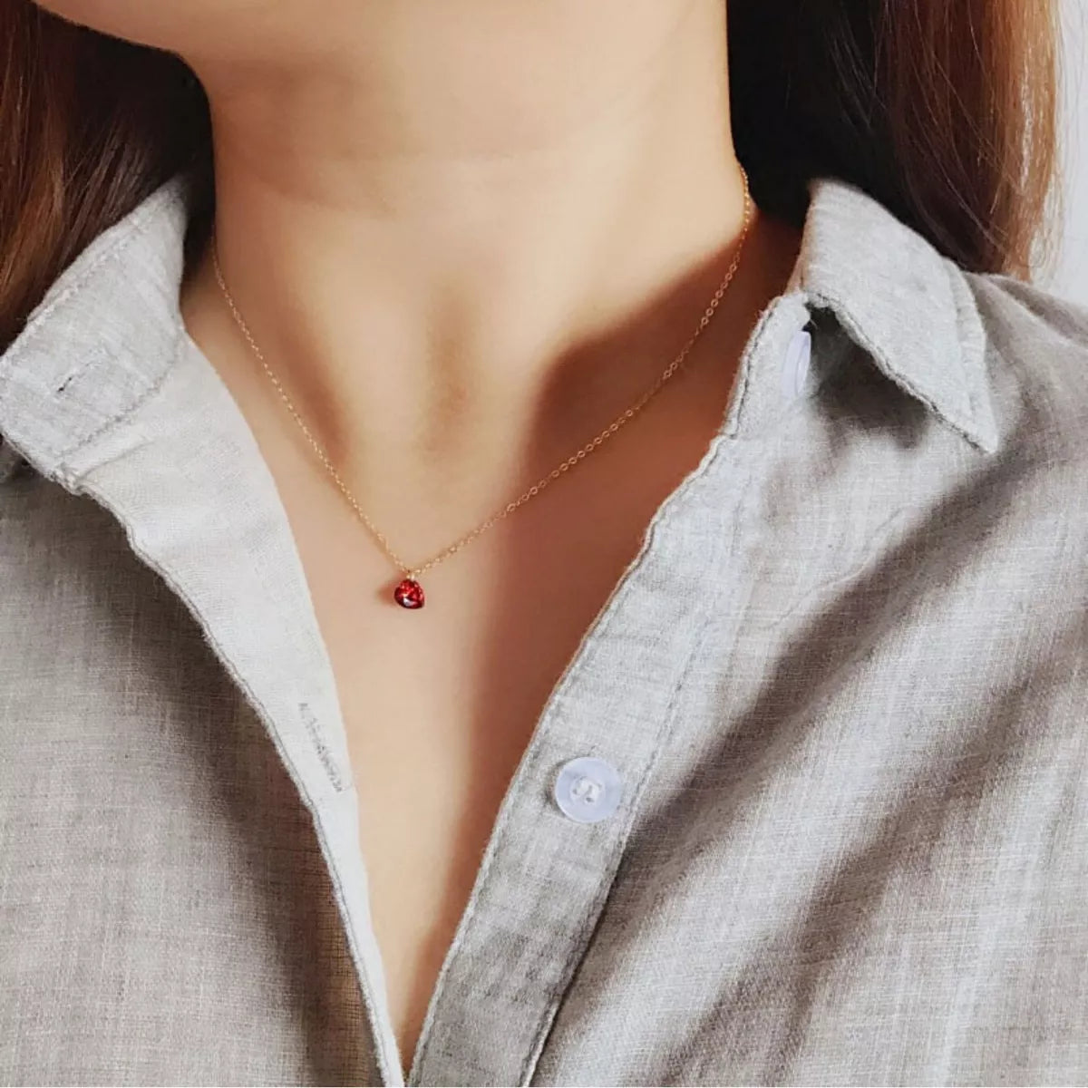 Rebellious Gal zircon heart necklace worn on model collarbone dainty look