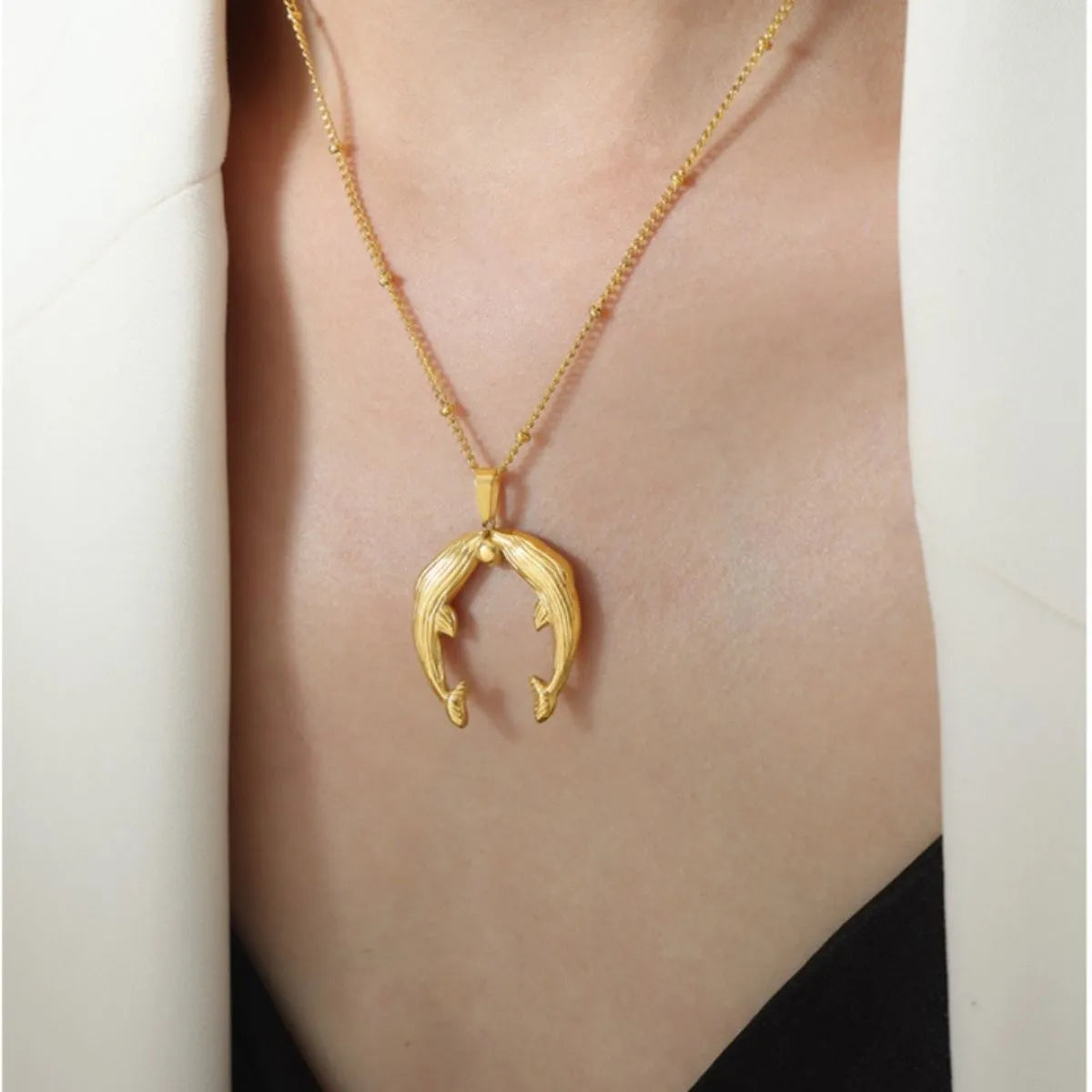 Kissing Dolphins Gold Plated Necklaces on Models Neckline Closeup| Rebellious Gal Jewelry