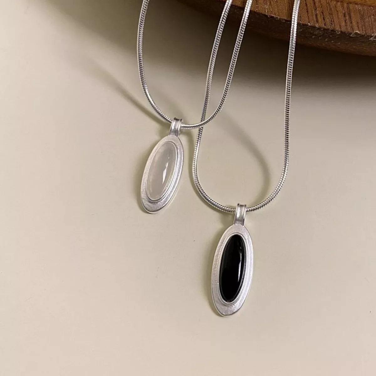 Close-up of natural agate stone set in geometric 925 sterling silver pendant