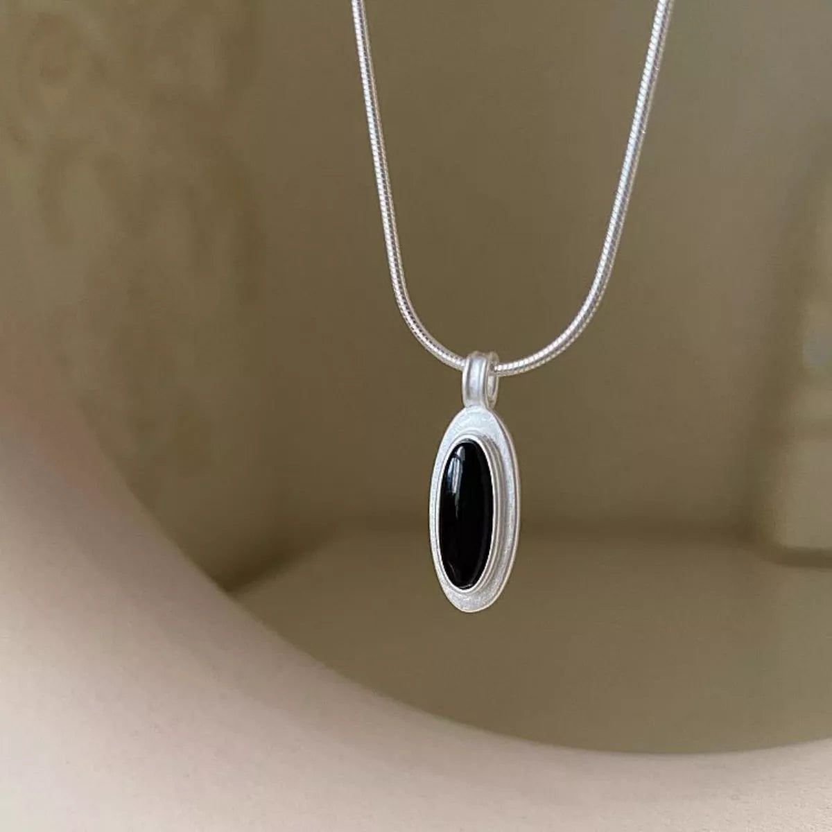 Detail of natural agate pattern and geometric sterling silver setting