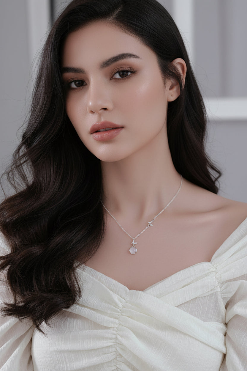 Necklace with a heart-shaped pendant on a model wearing a white top.