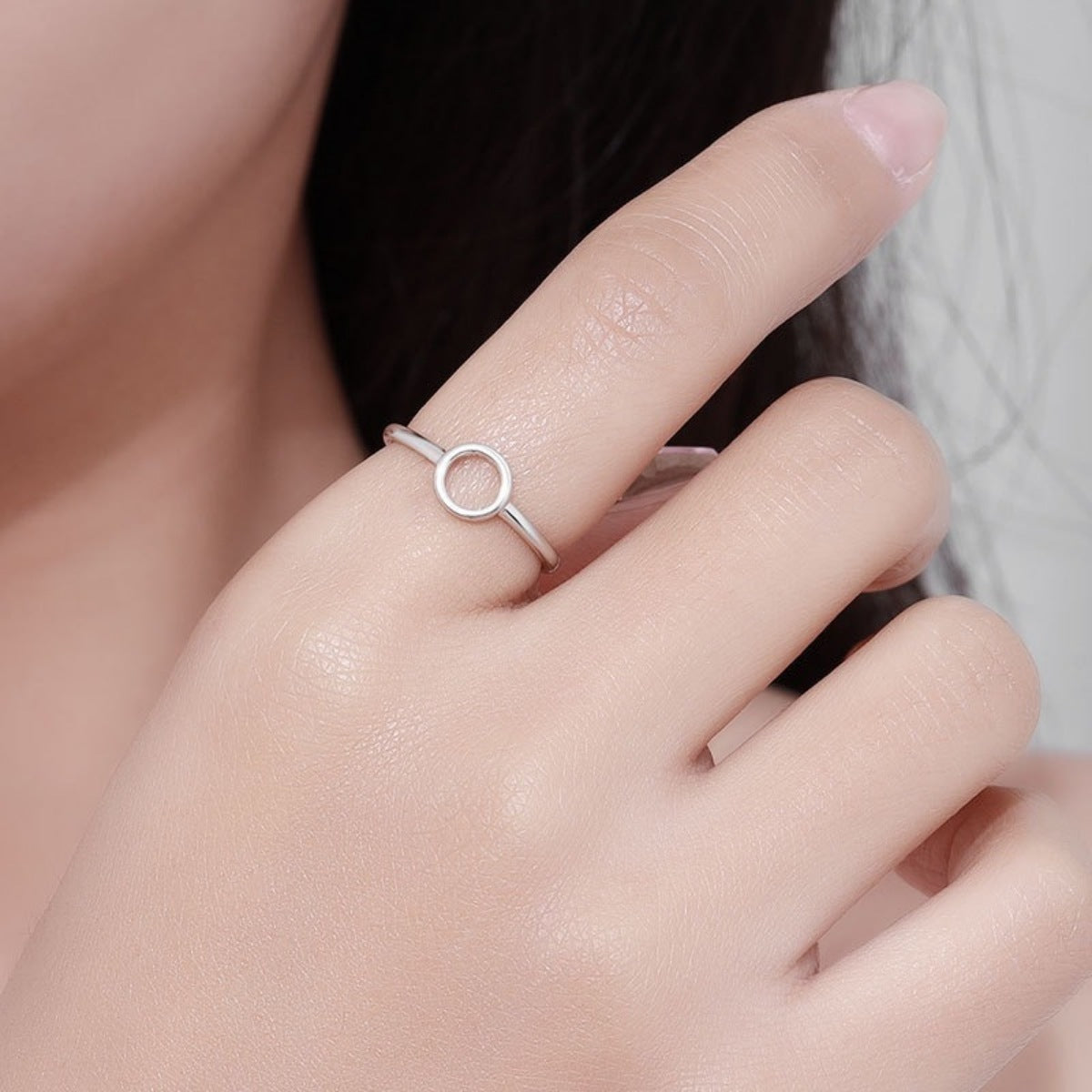 Model wearing Rebellious Gal circle ring with rebellious layered jewelry stack