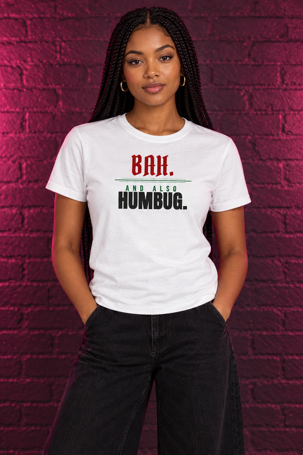 Woman with dark box braids in the white Bah and Also Humbug tee, brick wall