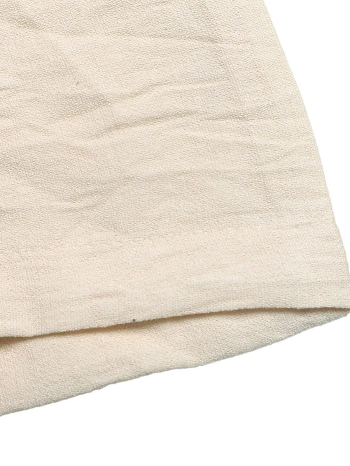 Close-up of a textured beige fabric on a white background