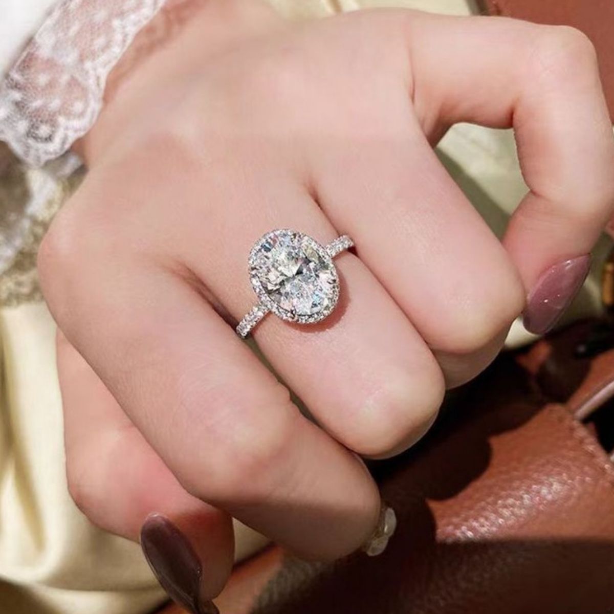 Model wearing Rebellious Gal 2 carat moissanite oval ring with rebellious layered jewelry