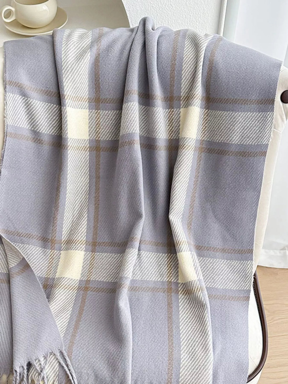 Overhead flat lay of 70.9" one-size plaid winter scarf with tassels