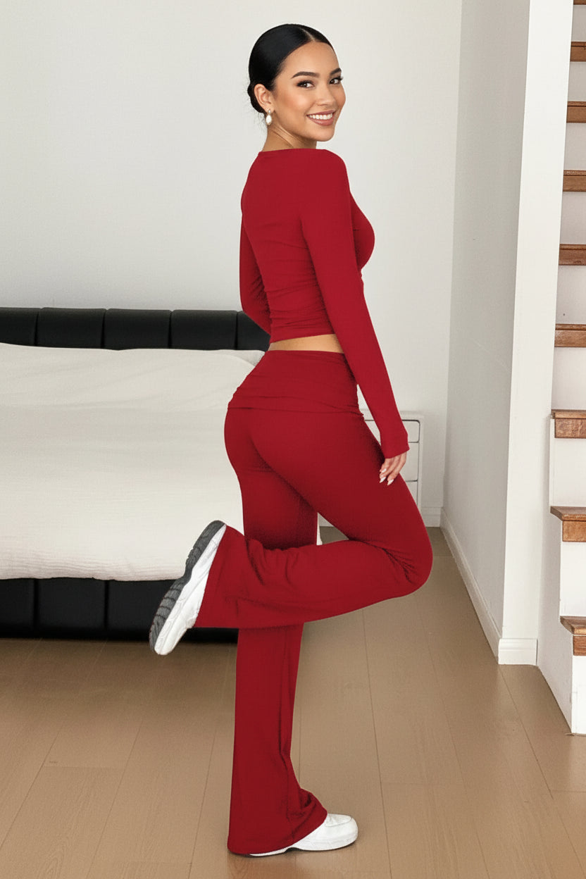 Person wearing a red outfit standing in a room with a white couch and wooden floor.