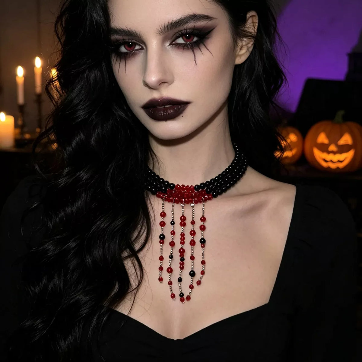 Black bead choker with red beaded fringe worn with a black sweetheart neckline top
