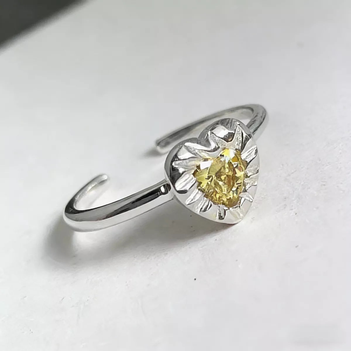Heart ring styled loosely on multiple fingers for rebellious stack look