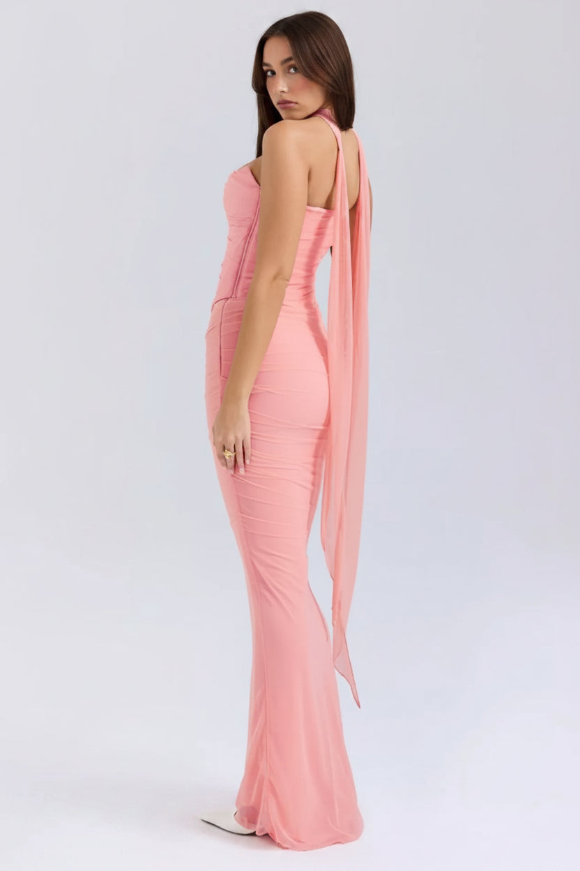 Pink evening gown with a slit on a white background