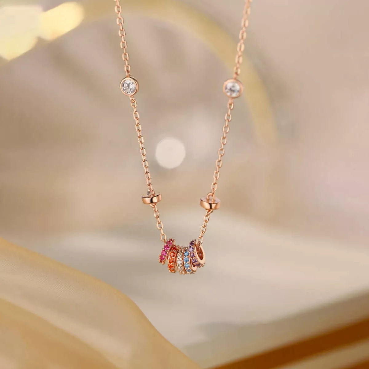 Side profile of rose gold zircon pendant necklace showing 15.7" chain and 2" extension