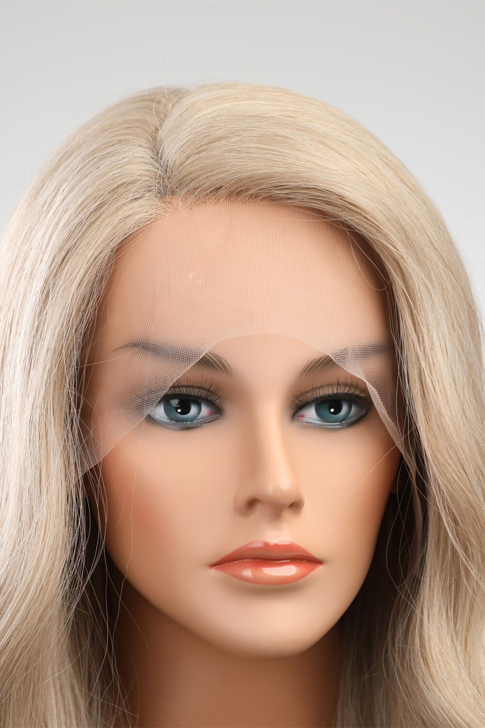 Studio mannequin wearing 25" heat-safe synthetic long wave wig with 150% density