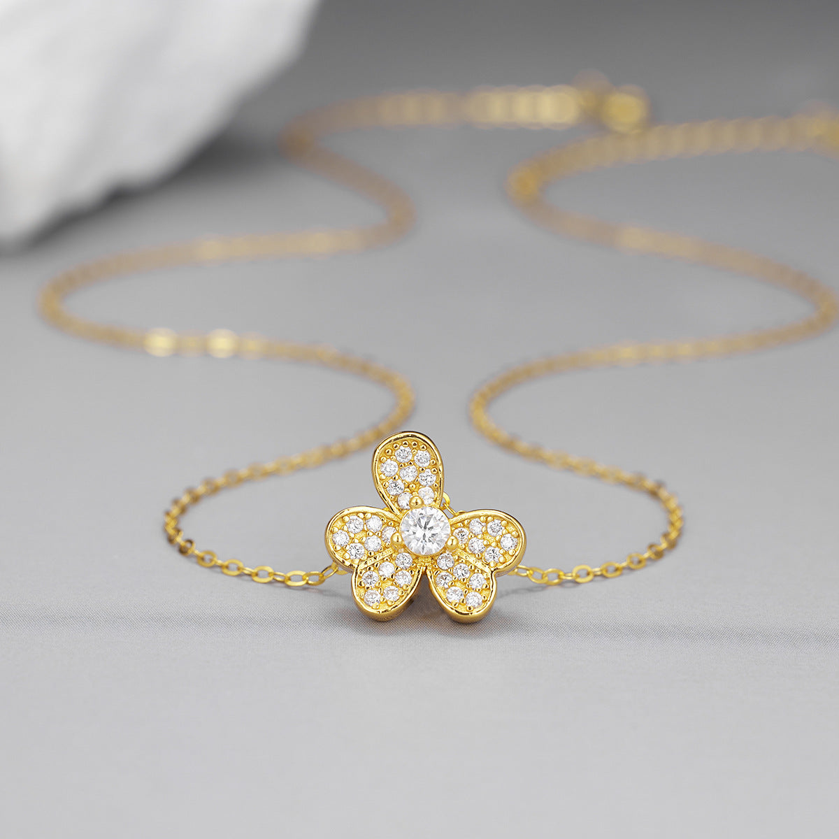 Close-up of sparkling zircon four leaf clover pendant lucky charm