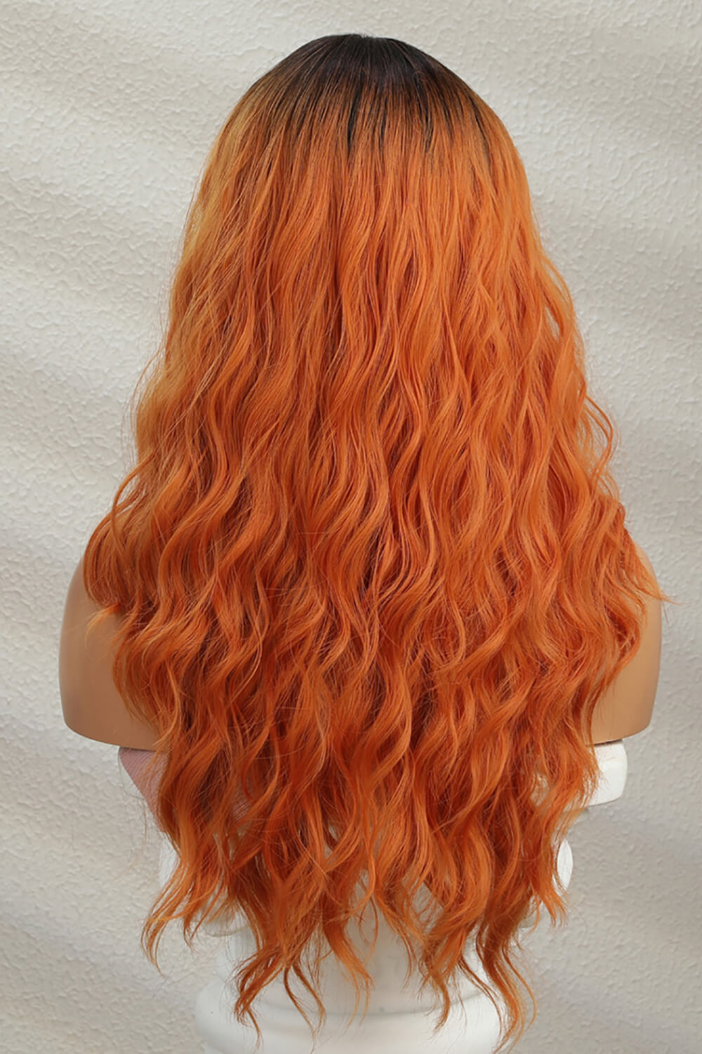 Front view of 24" long wavy synthetic wig with 13x2 lace front on mannequin back view