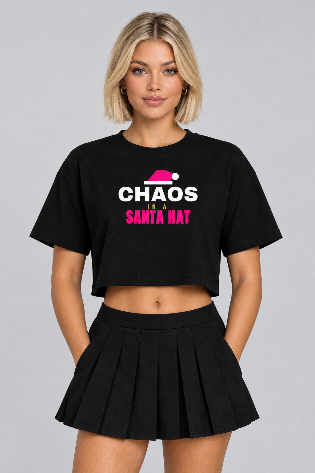 Woman with a blonde bob in the black Chaos Santa Hat crop top, studio backdrop
