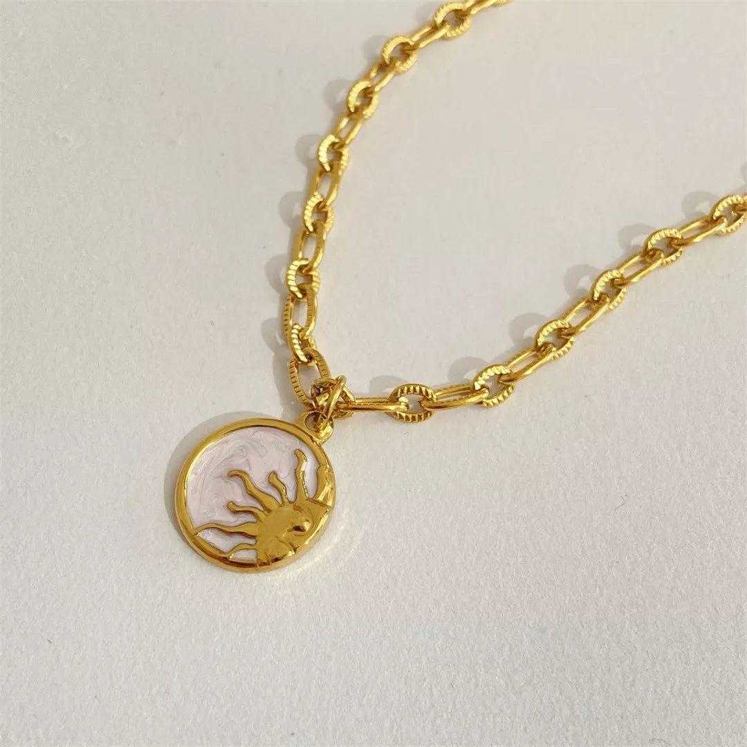 Gold bracelet with a lobster charm on a light gray background