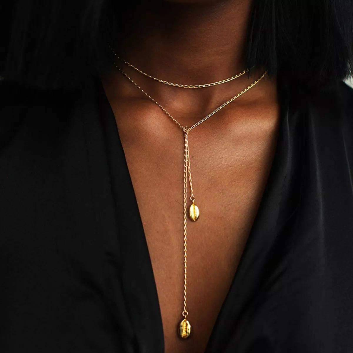 Rebellious Gal 43 inch gold plated chain necklace layered with pendants on model