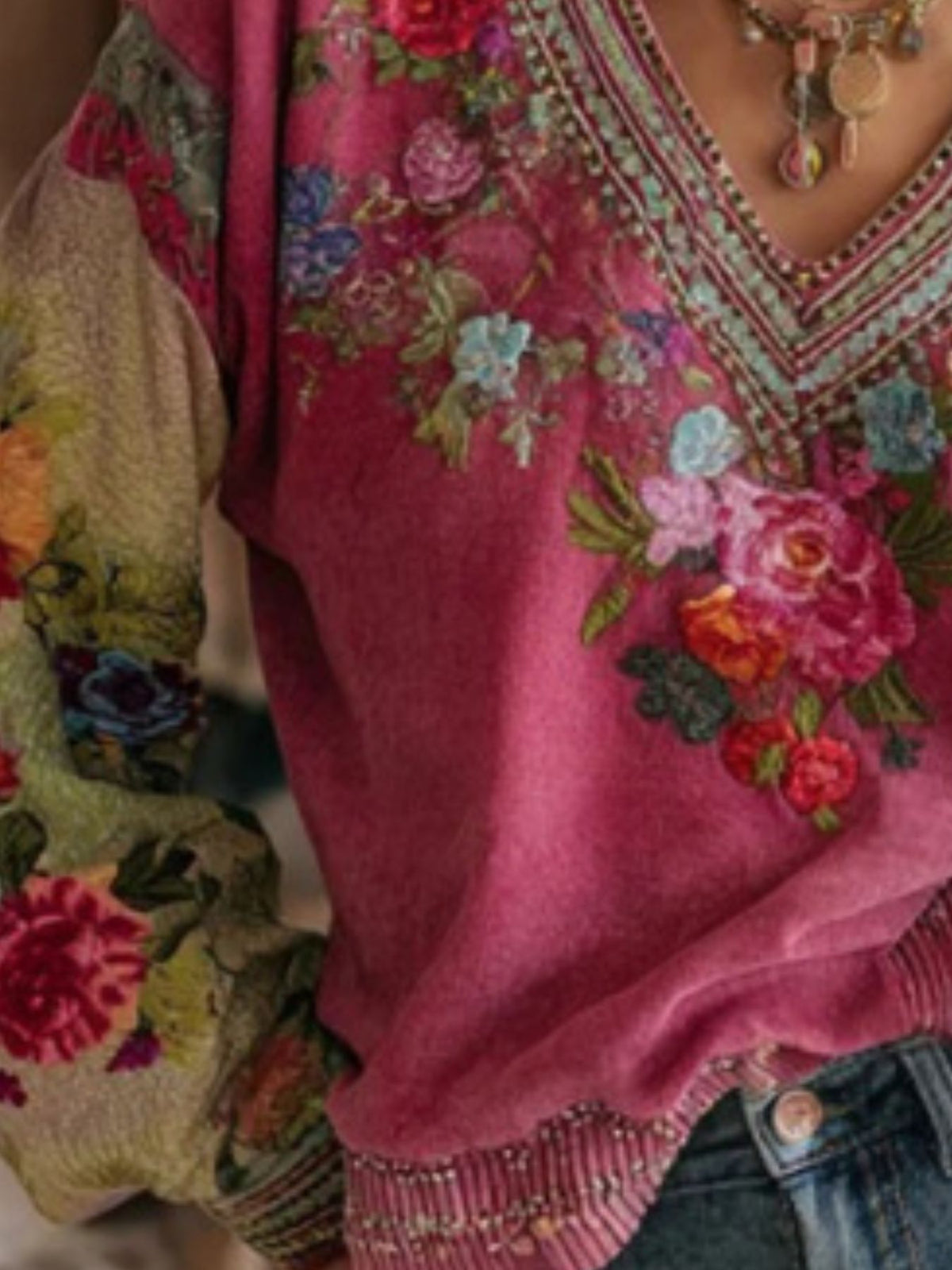 Close-up of a pink embroidered garment with floral patterns