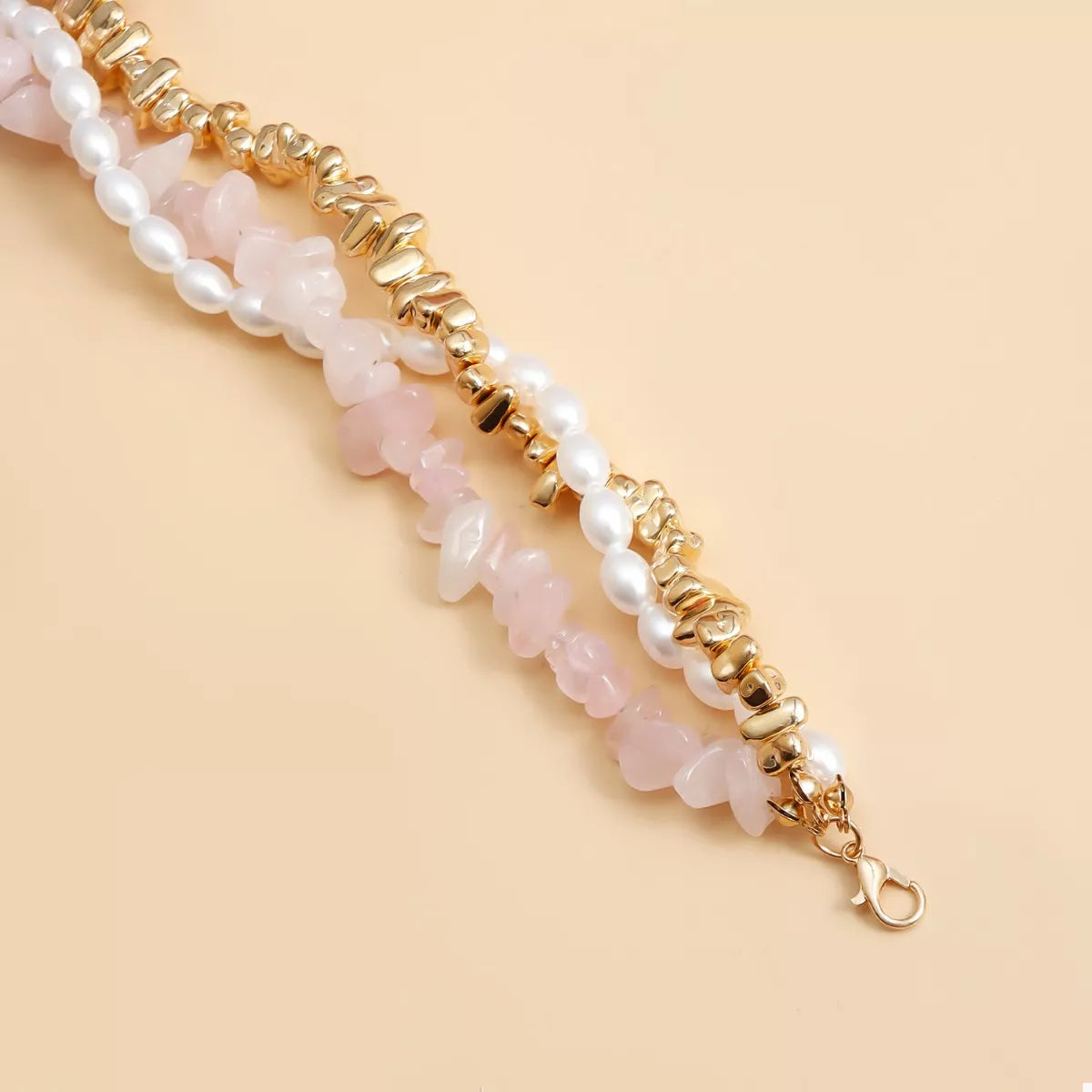 Three‑layer necklace with pearl and heart charms