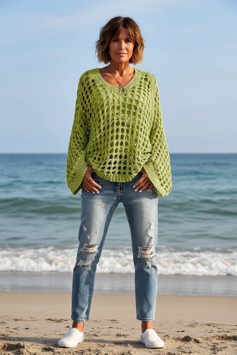 Person wearing a green lace sweater by the water