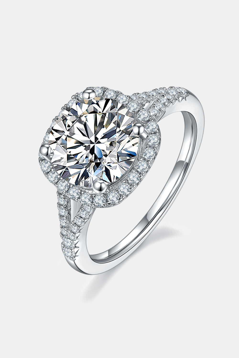Side profile of minimalist halo moissanite engagement ring showing band detail on white background