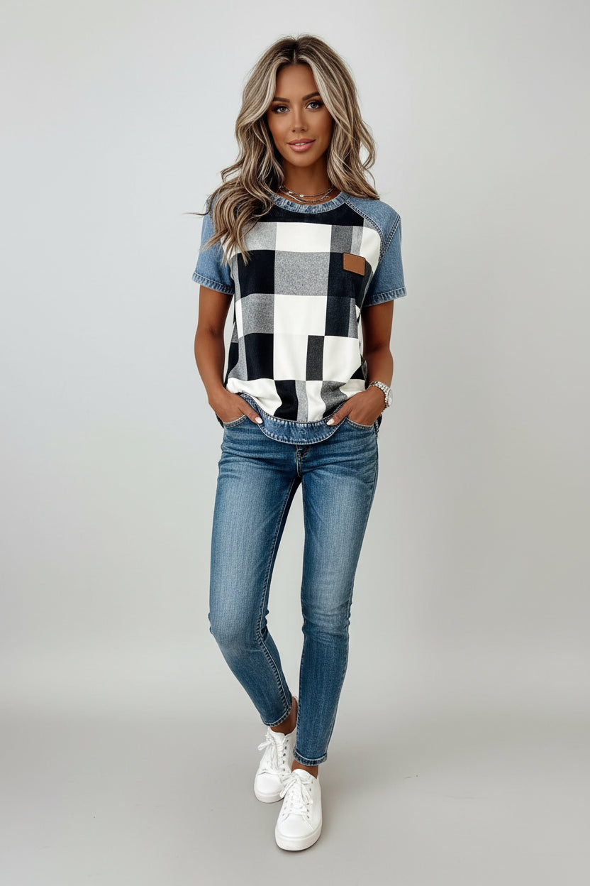 Person wearing a checkered shirt with denim sleeves and pants on a plain background