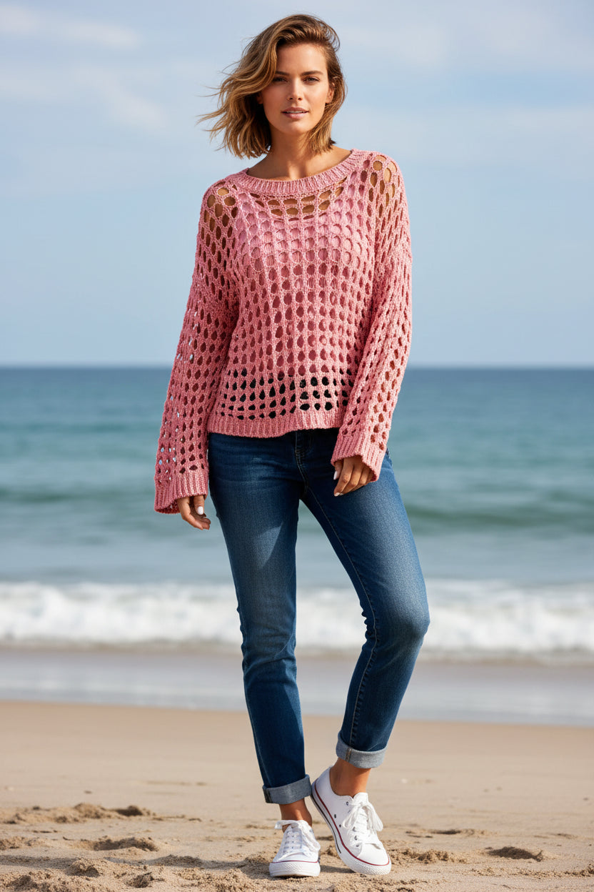 Close-up of a pink crochet shawl with a blurred background